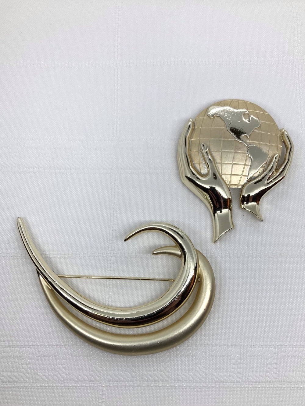 Two Large Gold Tone Statement Brooches - Whole World in Hands & Double Swirl